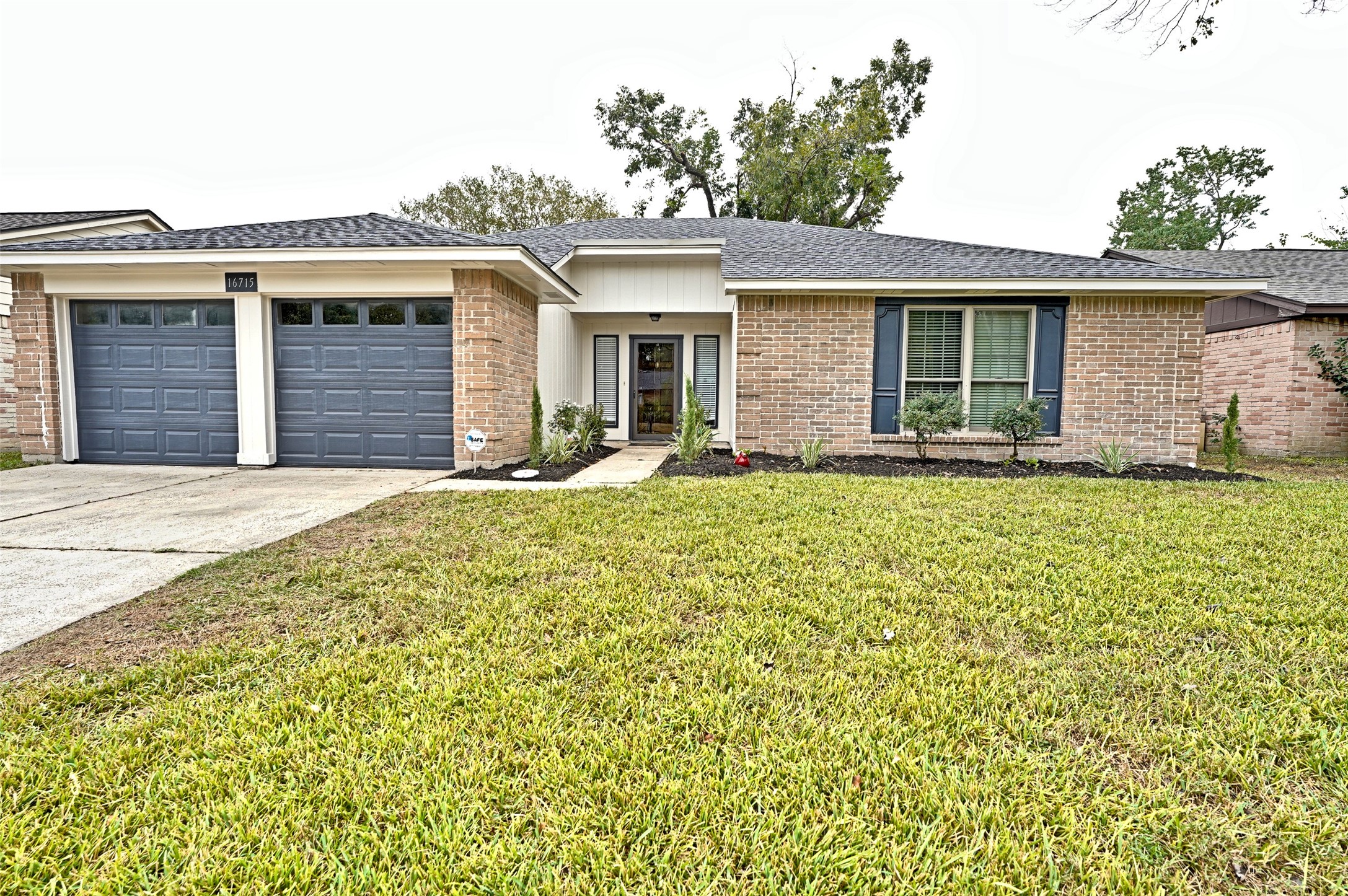 This charming brick home features a double garage, a well-maintained front yard, and a welcoming entryway. Its modern windows and neat landscaping offer great curb appeal.
