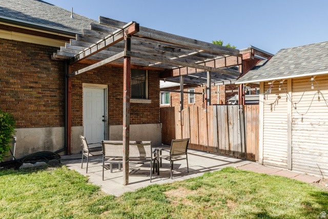 227 West 200 North Logan, UT 84321 - Photo 40 of 44 Brick exterior featuring a wood pergola over a concrete patio