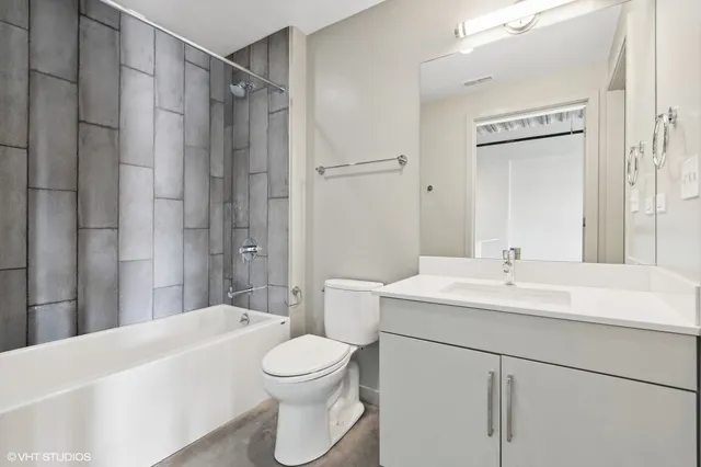 a bathroom with a sink toilet vanity and shower