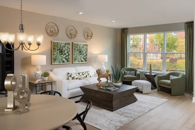 a living room with furniture a large window and a clock