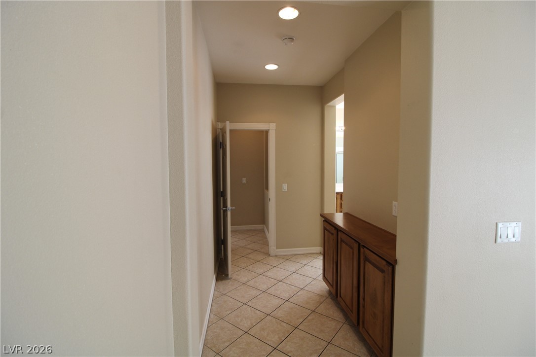 754 Rise Canyon Drive Henderson, NV 89052 - Photo 27 of 34 A well-lit corridor featuring integrated storage cabinetry and durable tile flooring.