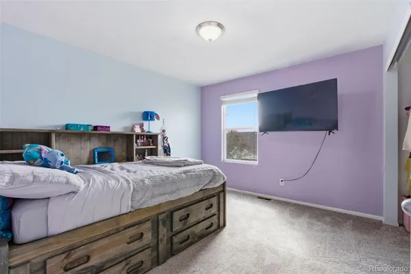 a bed room with a bed and a flat screen tv