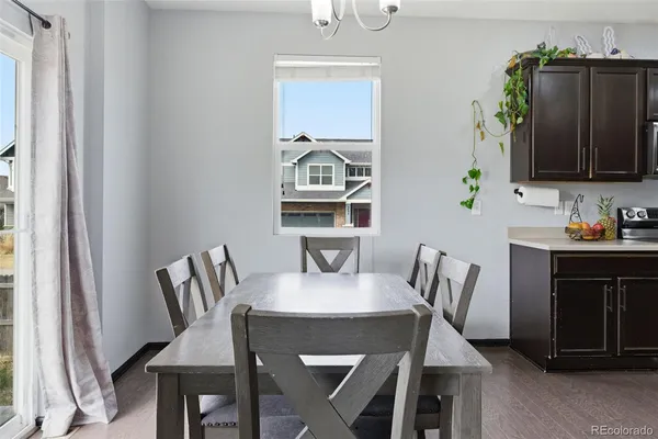 a view of a dining room with furniture and wooden floor