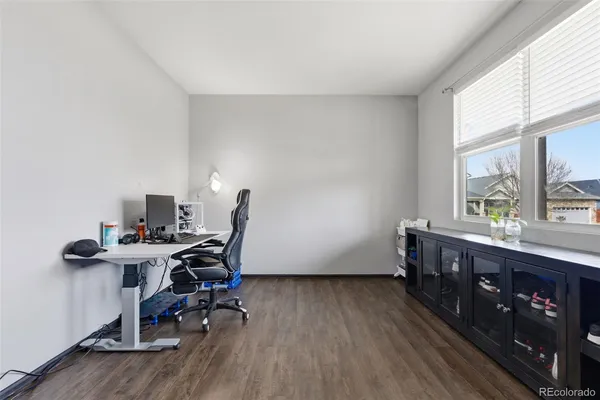 a view of a workspace with furniture and a window