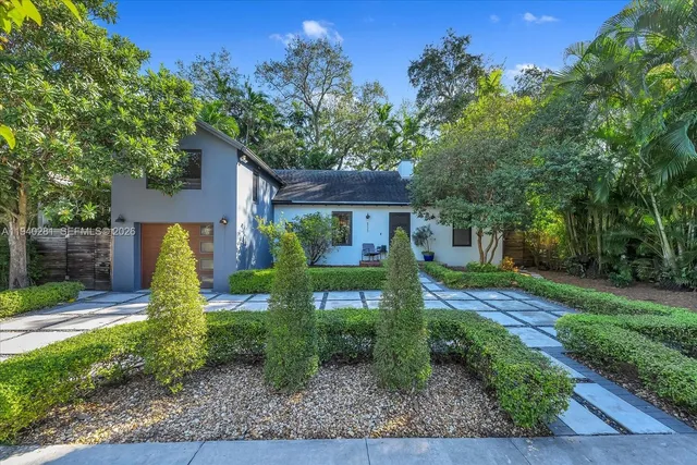 a front view of a house with garden