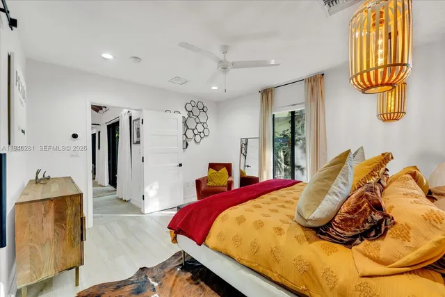 a bed sitting in a bedroom next to a window