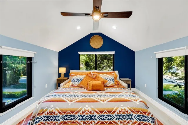 a bedroom with a bed and a large window