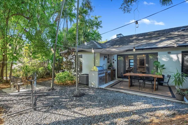 a view of a house with backyard porch and sitting area