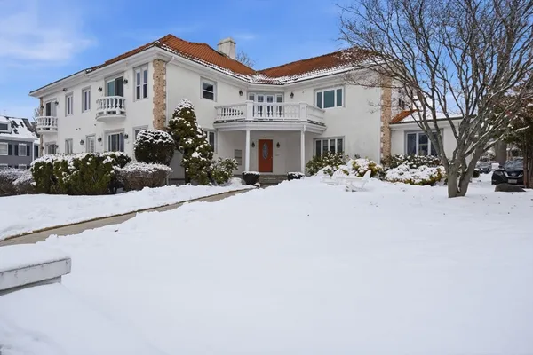 a view of a white house with a snow in the yard