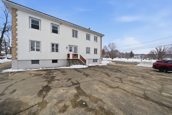 a view of a white house with a yard