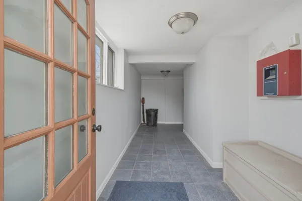 a view of hallway with stairs and wooden floor