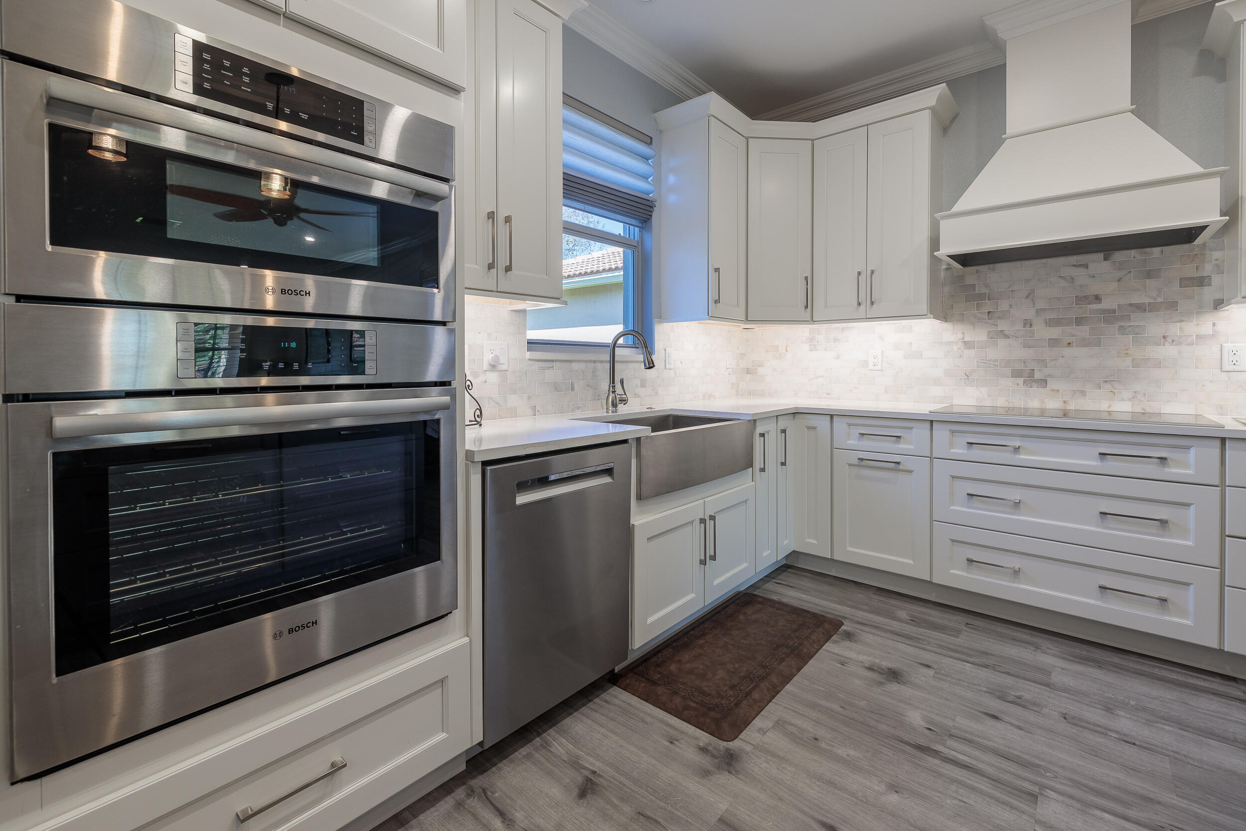 3285 Southwest Porpoise Circle Stuart, FL 34997 - Photo 14 of 69 a kitchen with a stove microwave and cabinets