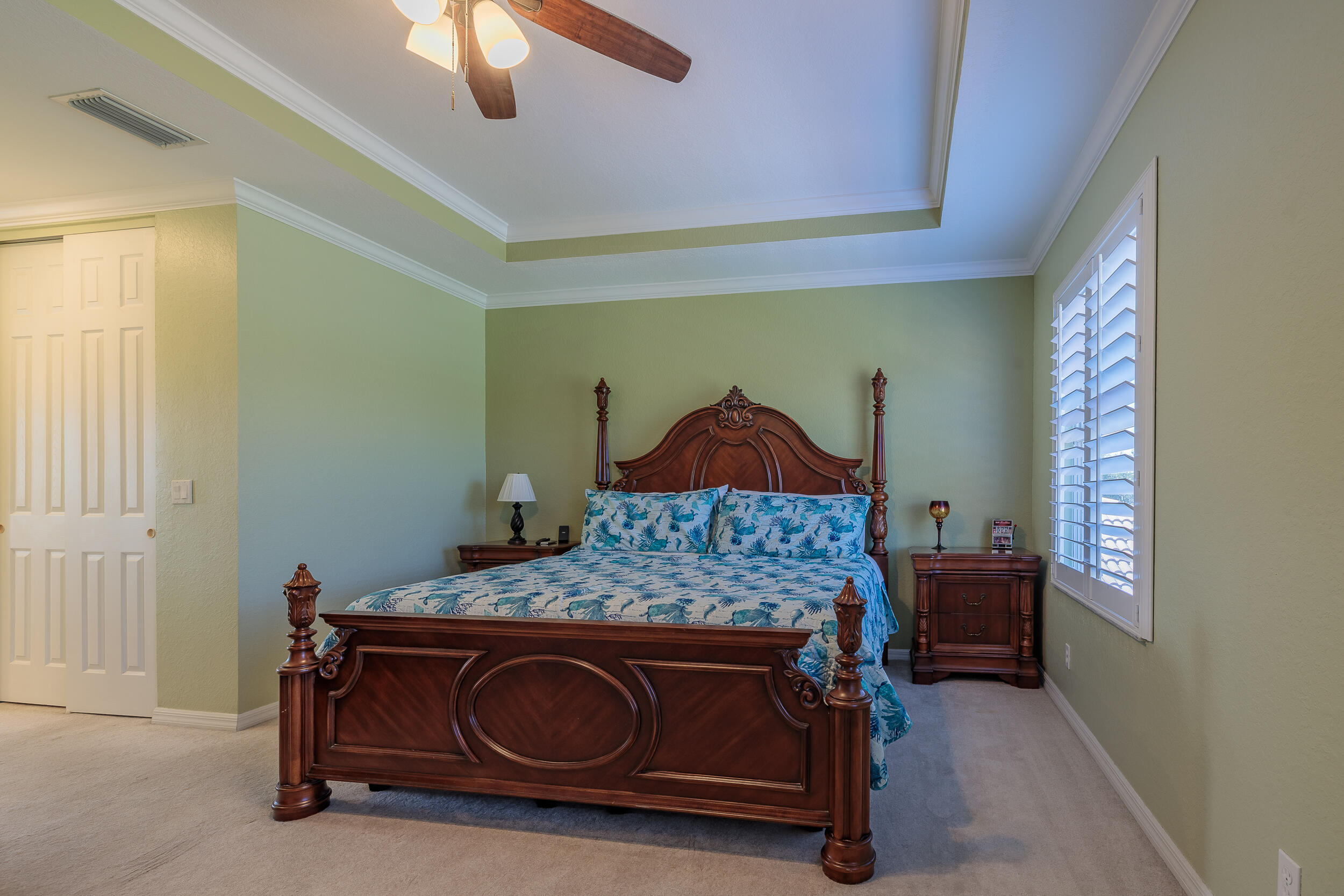 3285 Southwest Porpoise Circle Stuart, FL 34997 - Photo 23 of 69 a bedroom with a bed and a chandelier