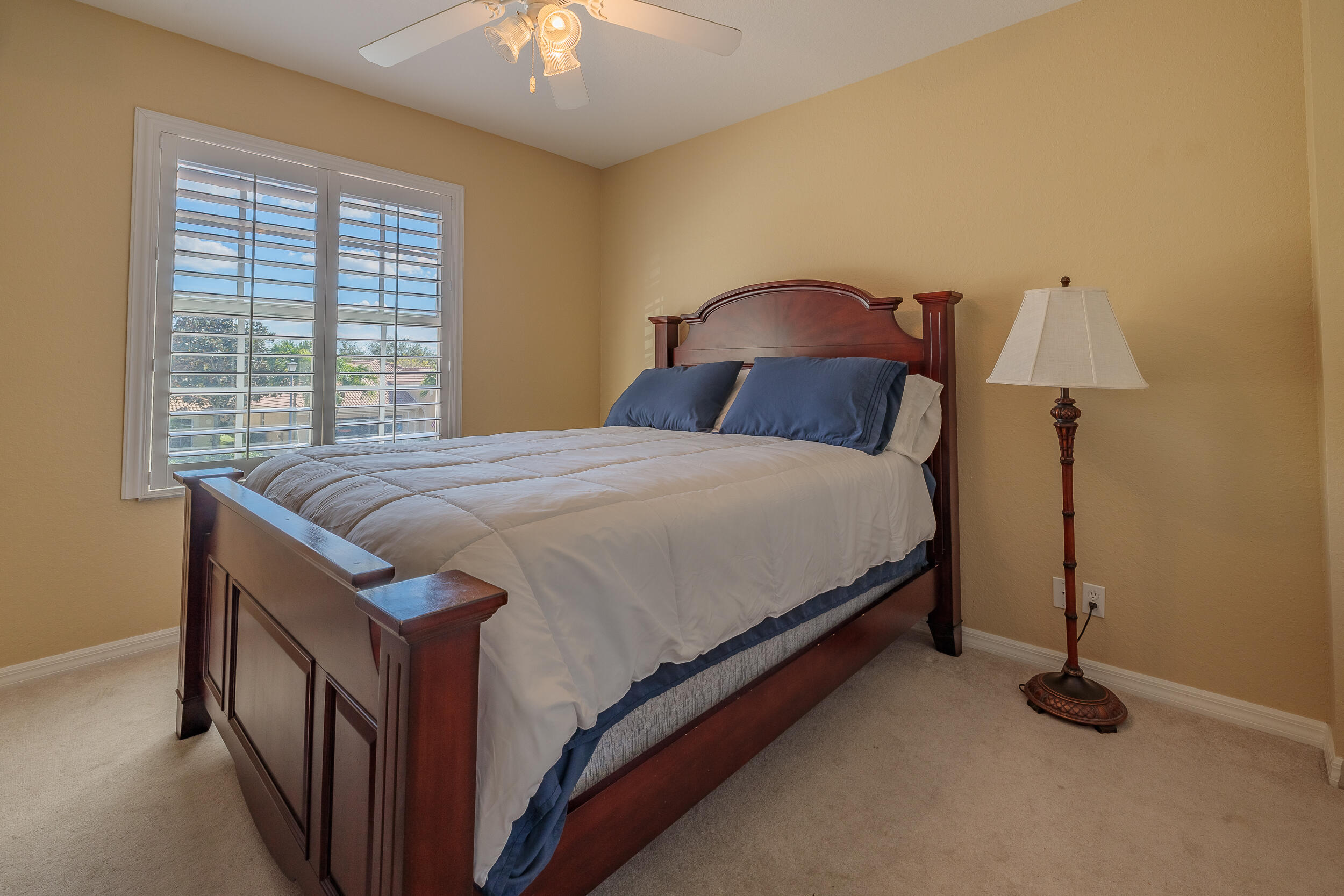 3285 Southwest Porpoise Circle Stuart, FL 34997 - Photo 27 of 69 a bedroom with a bed and a chandelier