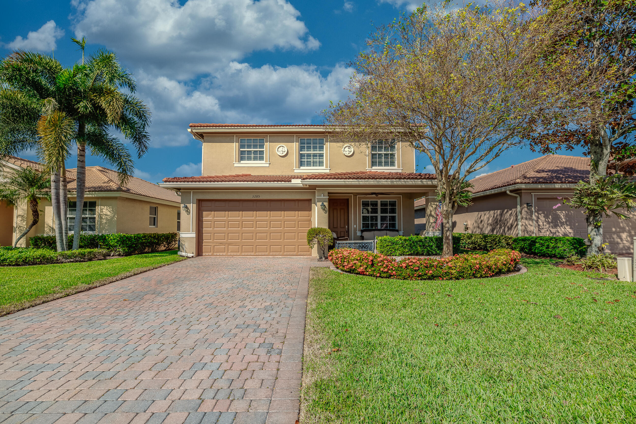3285 Southwest Porpoise Circle Stuart, FL 34997 - Photo 3 of 69 a front view of a house with a yard and garage