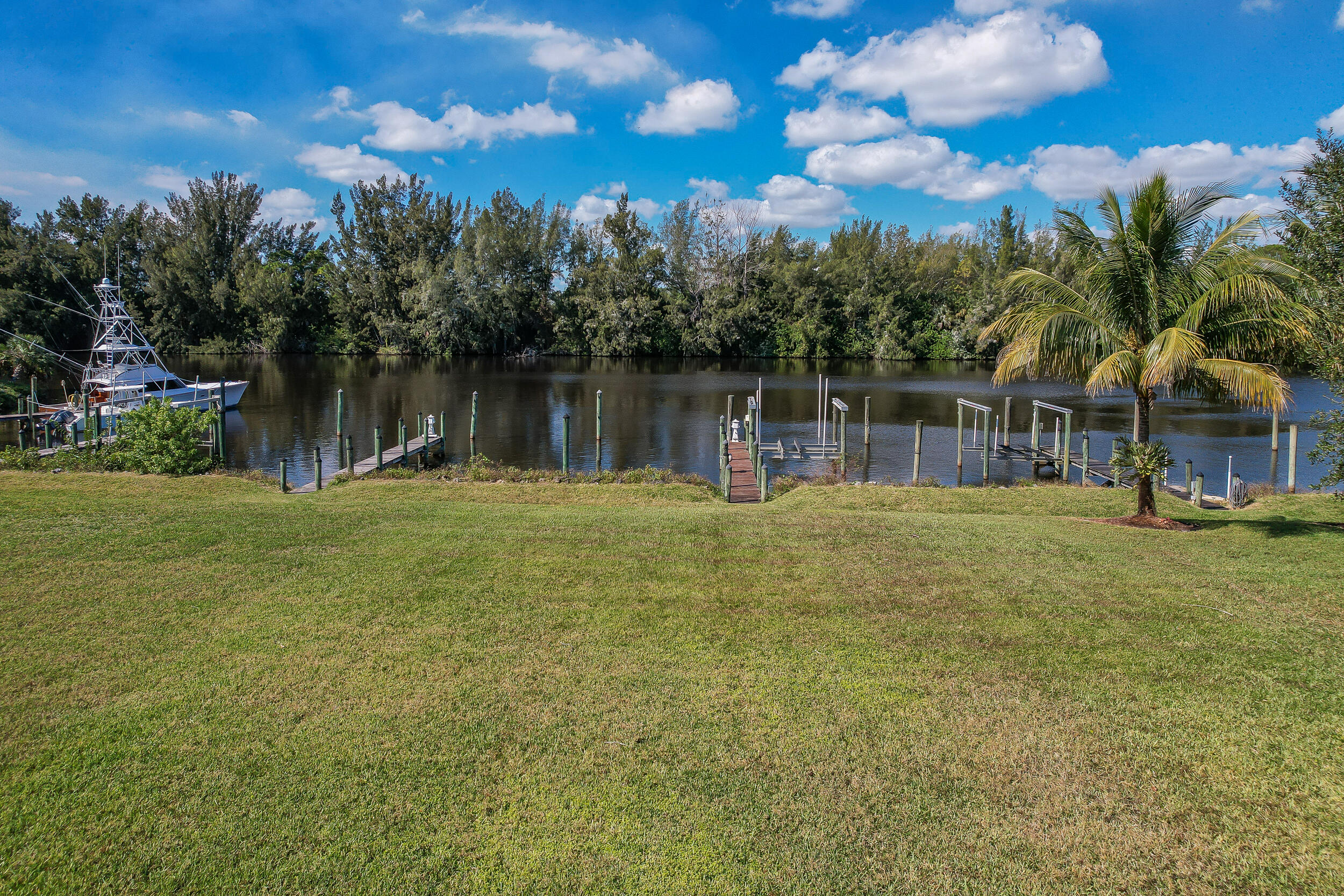 3285 Southwest Porpoise Circle Stuart, FL 34997 - Photo 61 of 69 a backyard of a house with lots of green space