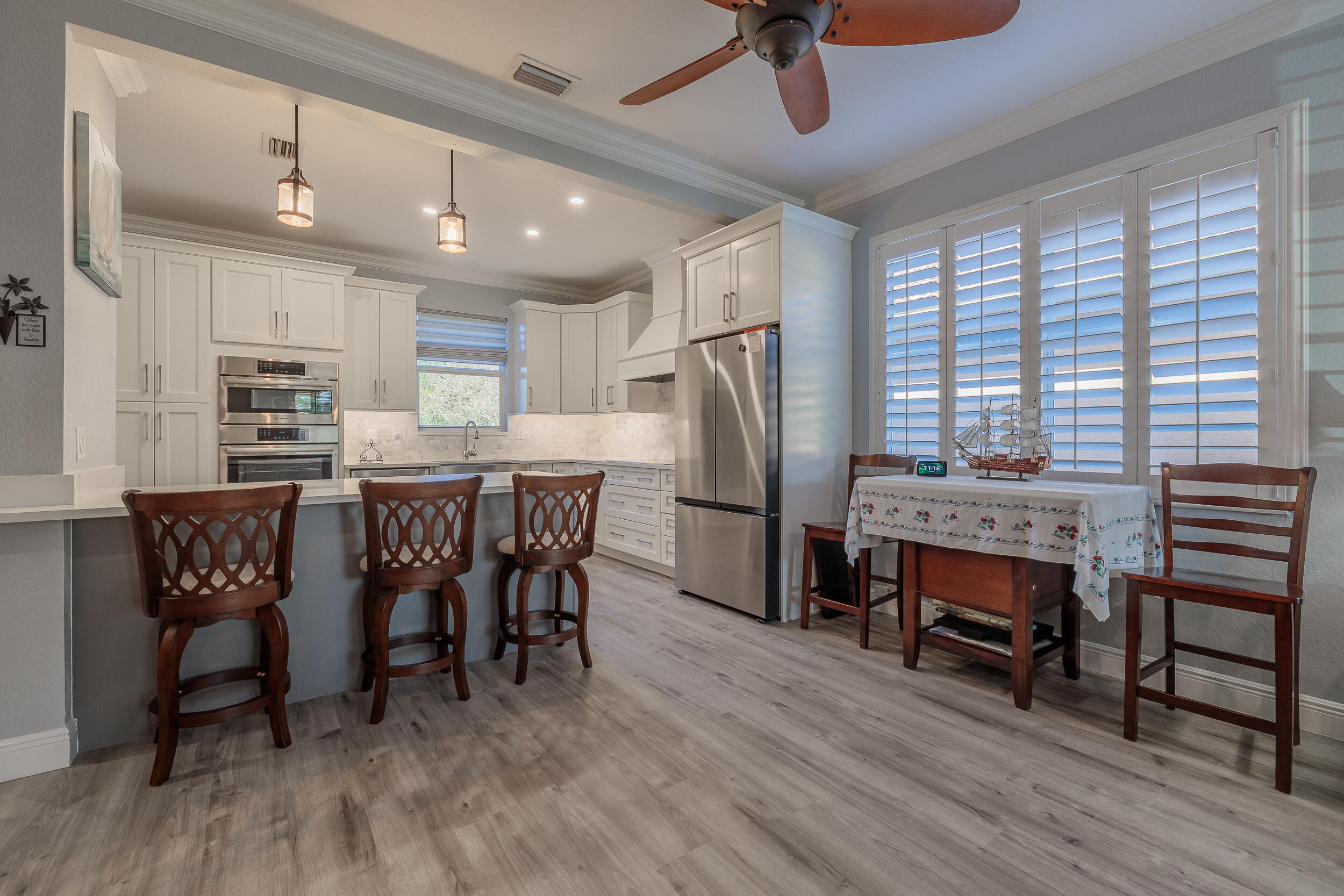 3285 Southwest Porpoise Circle Stuart, FL 34997 - Photo 10 of 69 a dining room with furniture and wooden floor