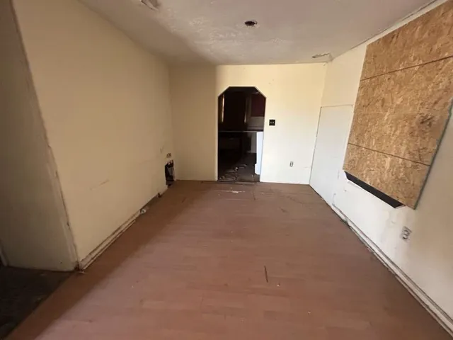 a view of a big room with entryway and stairs