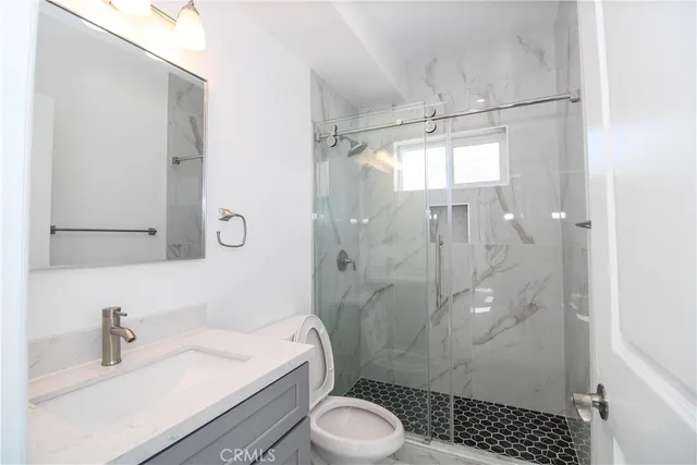 a bathroom with a sink toilet and shower