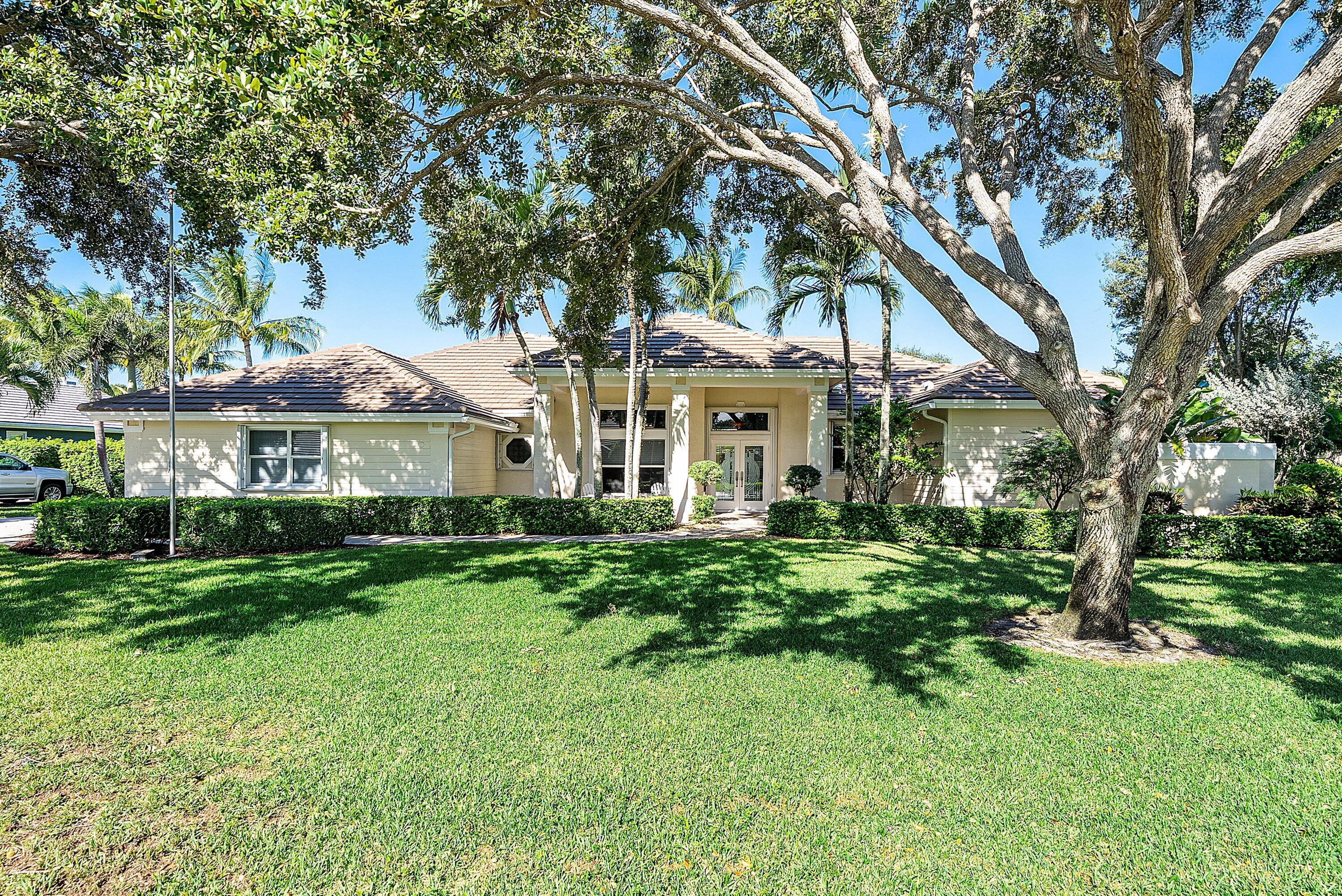18670 Southeast Lakeside Way Jupiter, FL 33469 - Photo 1 of 56 a front view of a house with a yard