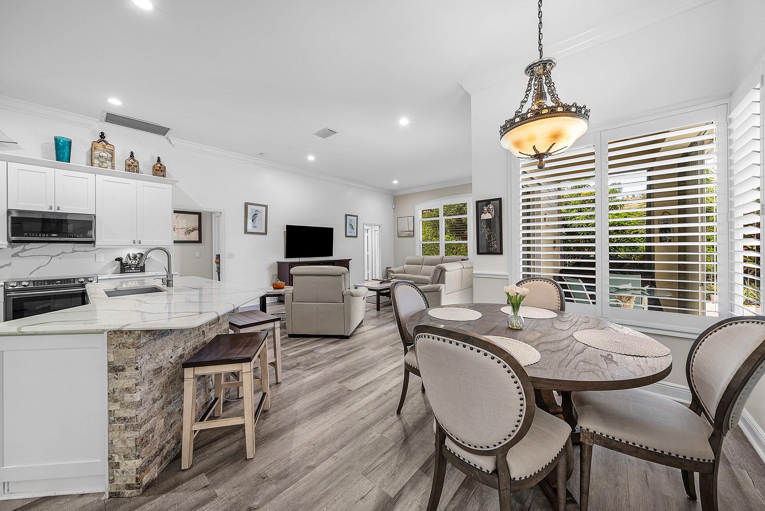 18670 Southeast Lakeside Way Jupiter, FL 33469 - Photo 13 of 56 a view of a dining room with furniture window and wooden floor