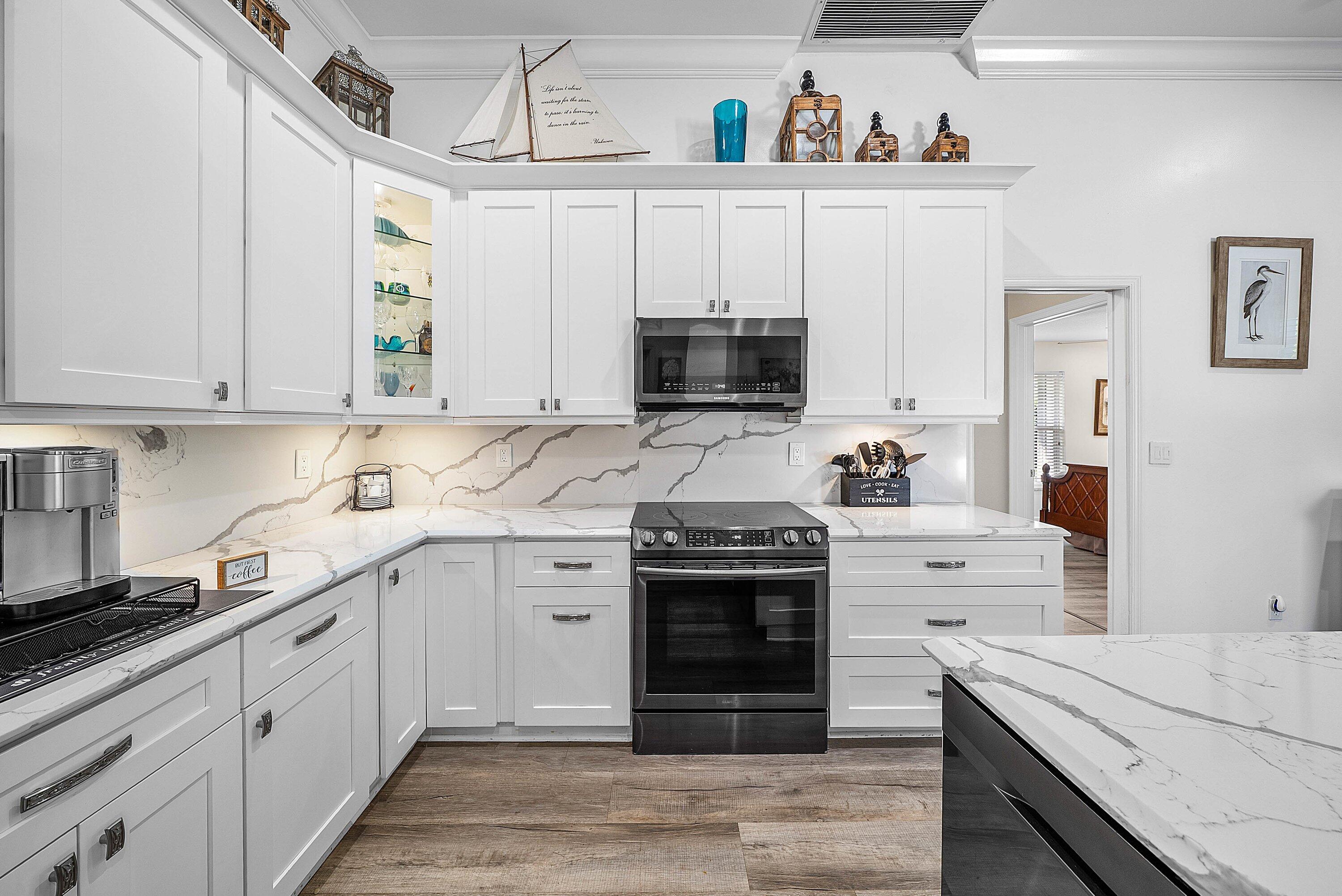 18670 Southeast Lakeside Way Jupiter, FL 33469 - Photo 16 of 56 a kitchen with granite countertop a sink and cabinets