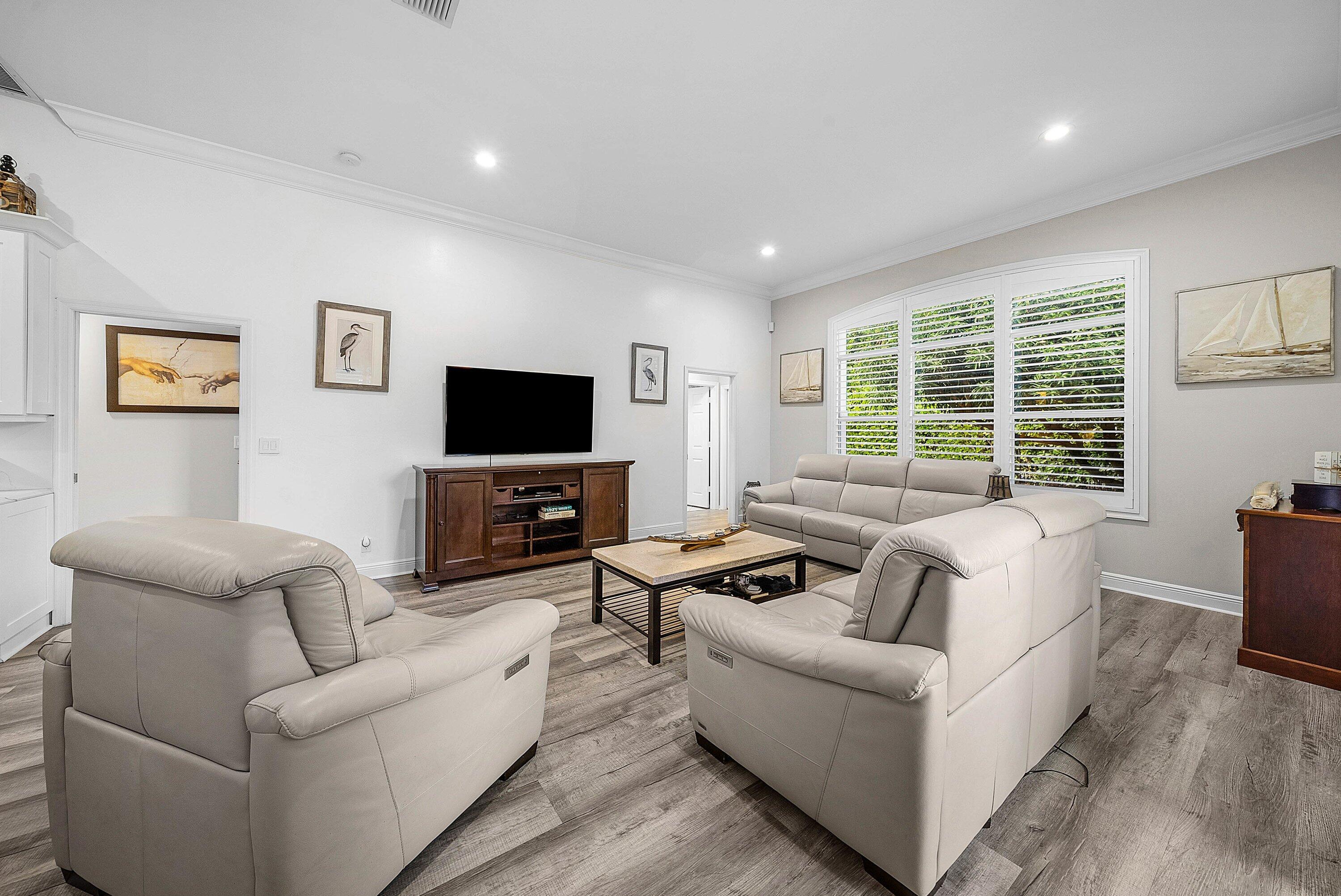 18670 Southeast Lakeside Way Jupiter, FL 33469 - Photo 19 of 56 a living room with furniture and a flat screen tv