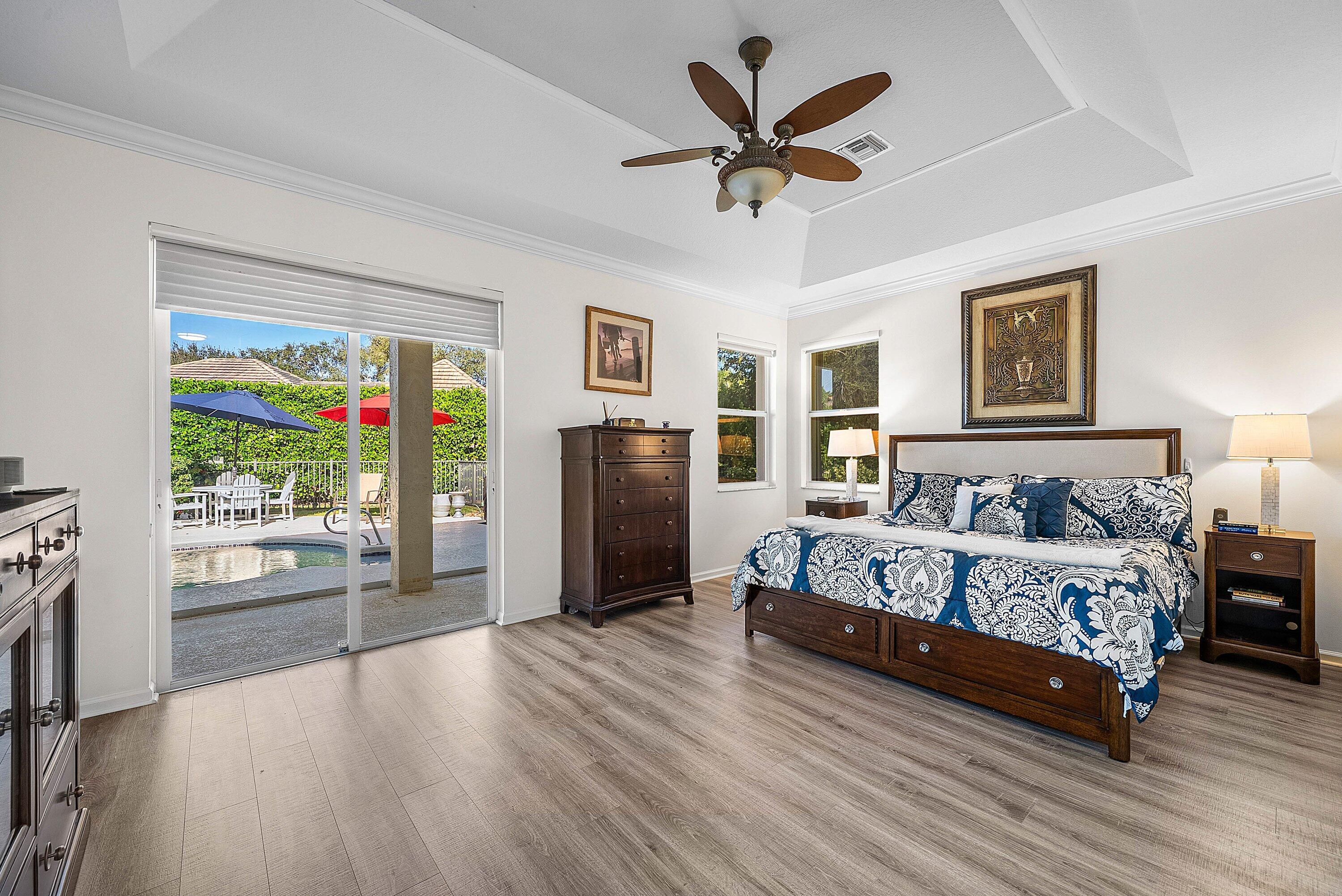 18670 Southeast Lakeside Way Jupiter, FL 33469 - Photo 21 of 56 a spacious bedroom with a bed painting on wall and a large window