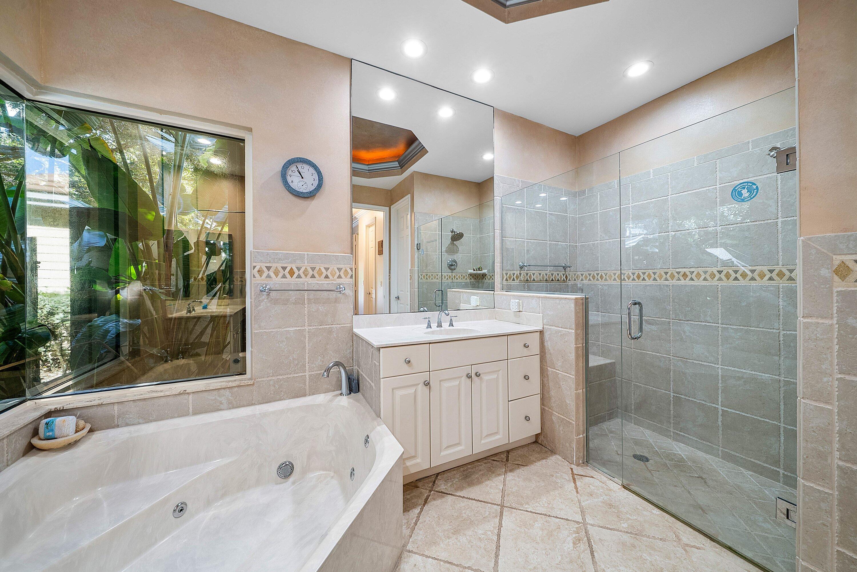 18670 Southeast Lakeside Way Jupiter, FL 33469 - Photo 24 of 56 a bathroom with a bathtub shower sink and mirror