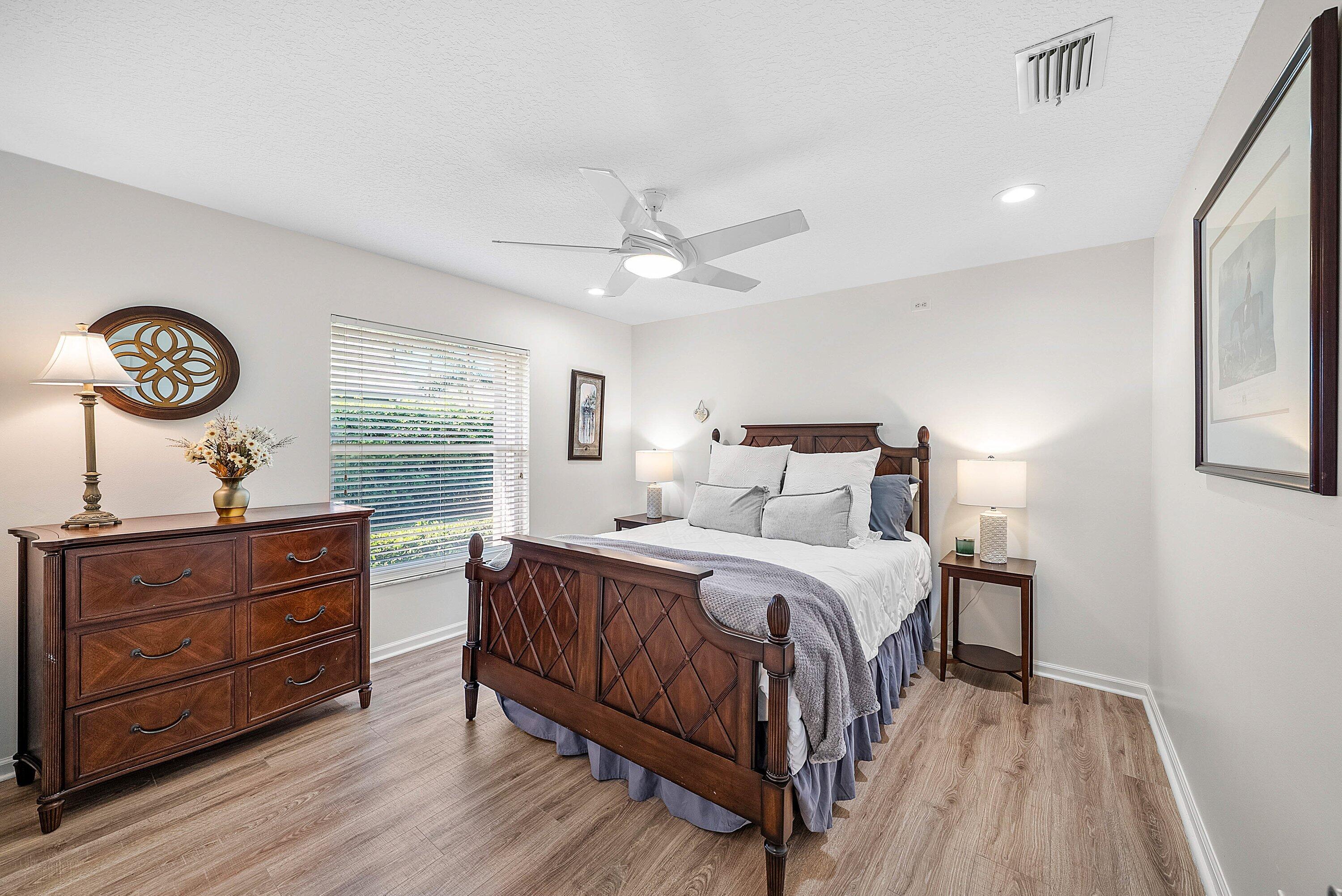 18670 Southeast Lakeside Way Jupiter, FL 33469 - Photo 25 of 56 a bedroom with a bed and a table