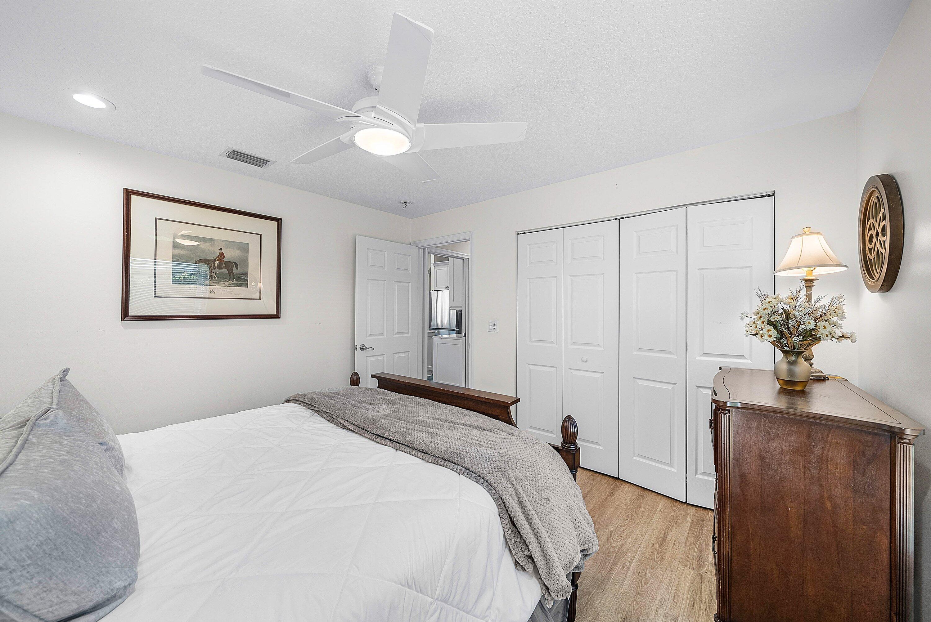 18670 Southeast Lakeside Way Jupiter, FL 33469 - Photo 26 of 56 a bedroom with a large bed and a chandelier