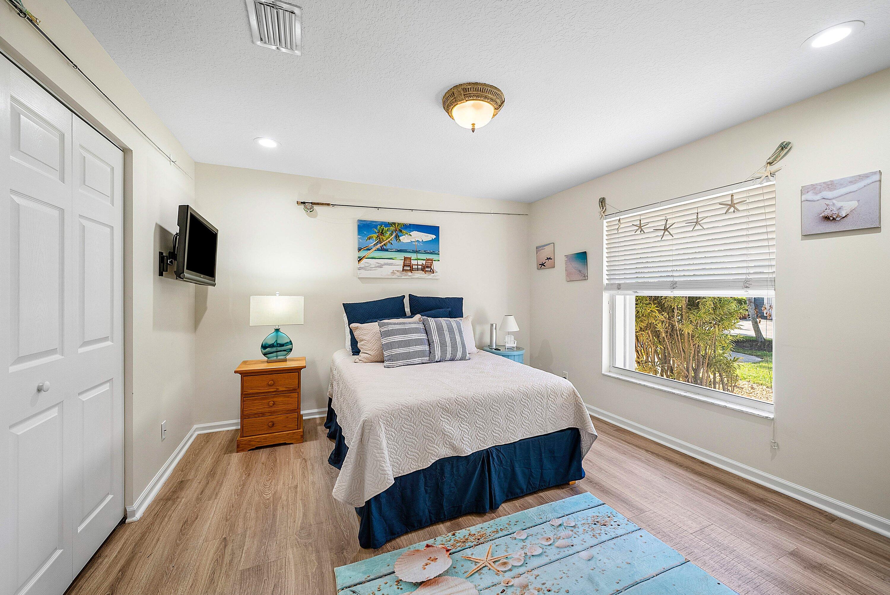 18670 Southeast Lakeside Way Jupiter, FL 33469 - Photo 28 of 56 a bedroom with a bed and a window