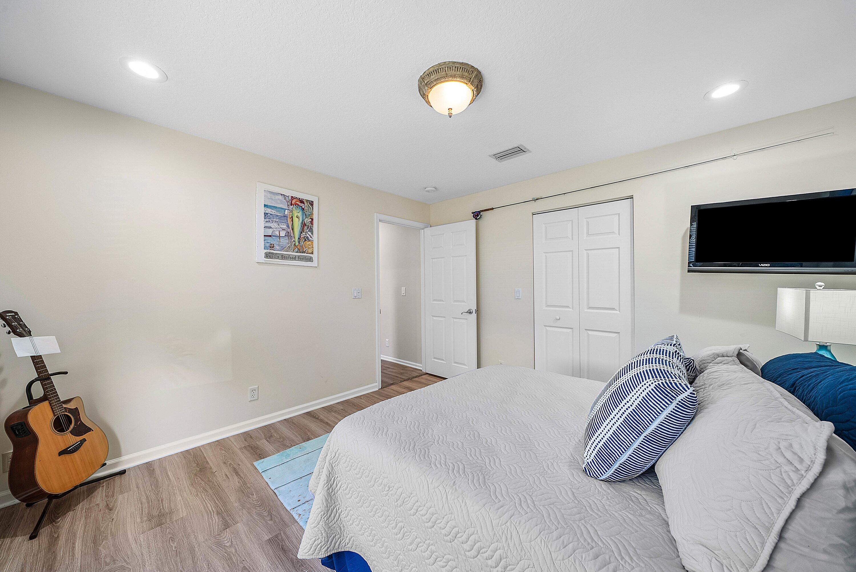 18670 Southeast Lakeside Way Jupiter, FL 33469 - Photo 29 of 56 a bedroom with a bed and a flat screen tv