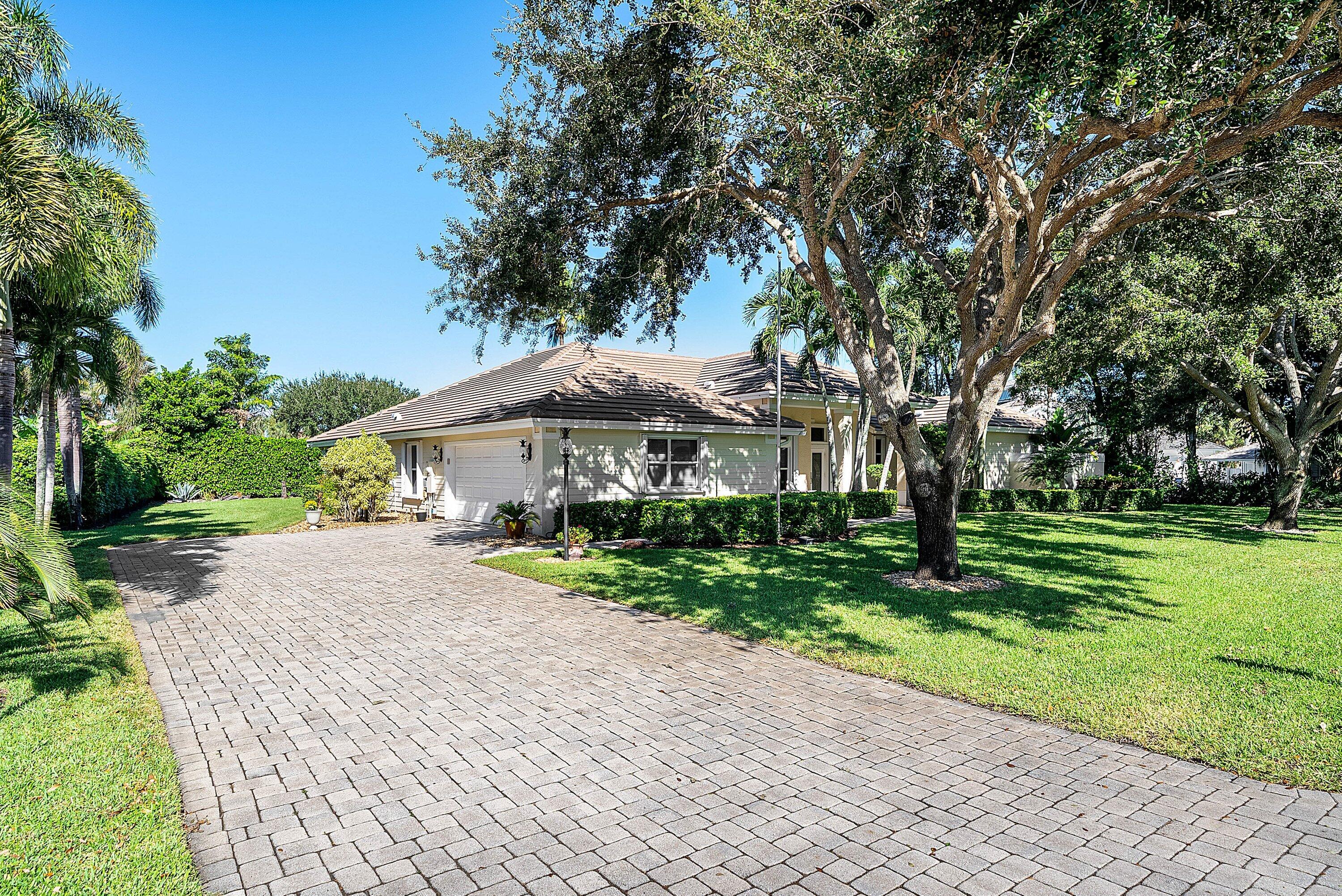 18670 Southeast Lakeside Way Jupiter, FL 33469 - Photo 3 of 56 a view of a patio with a table and chairs under an umbrella