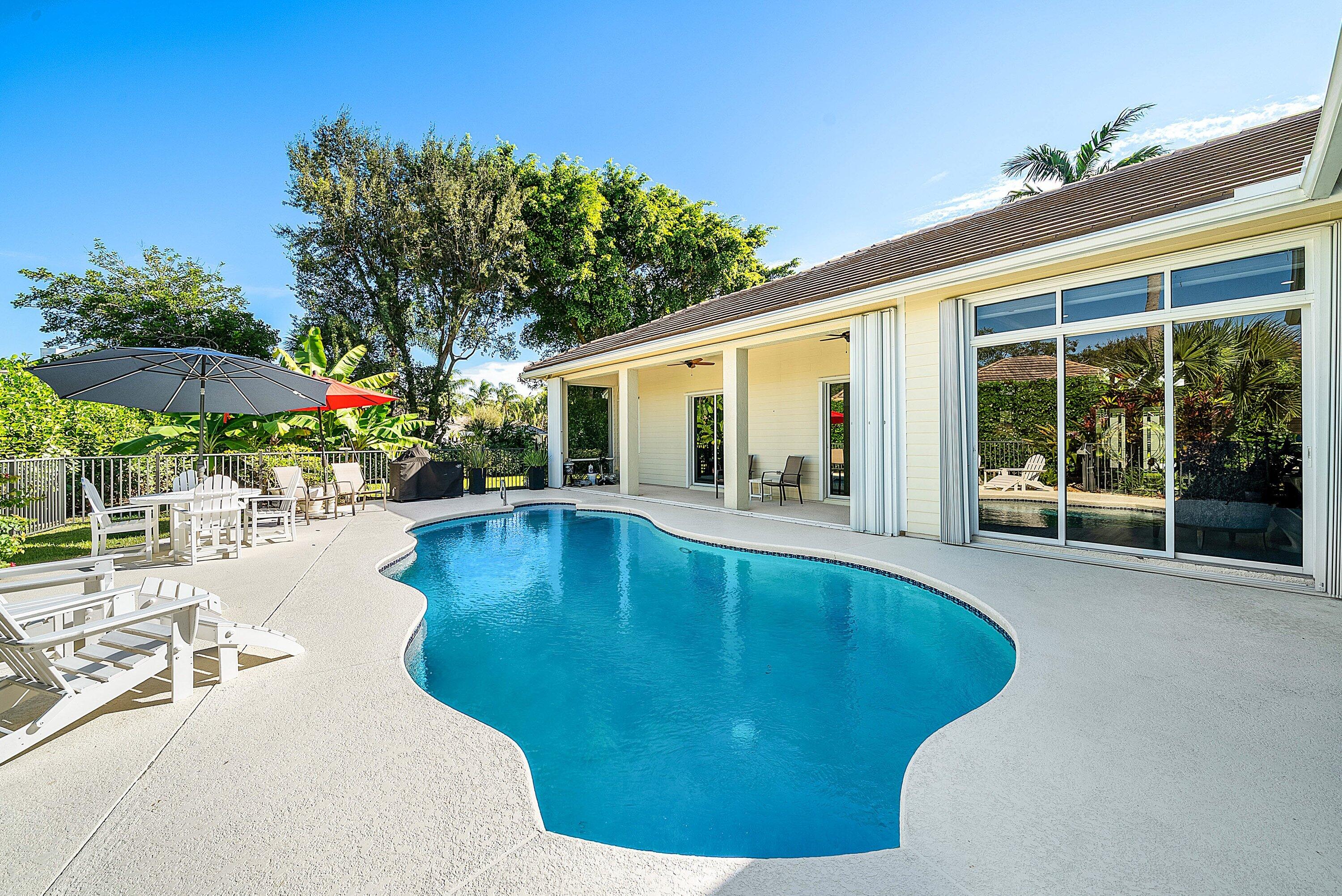 18670 Southeast Lakeside Way Jupiter, FL 33469 - Photo 39 of 56 a swimming pool with outdoor seating and yard