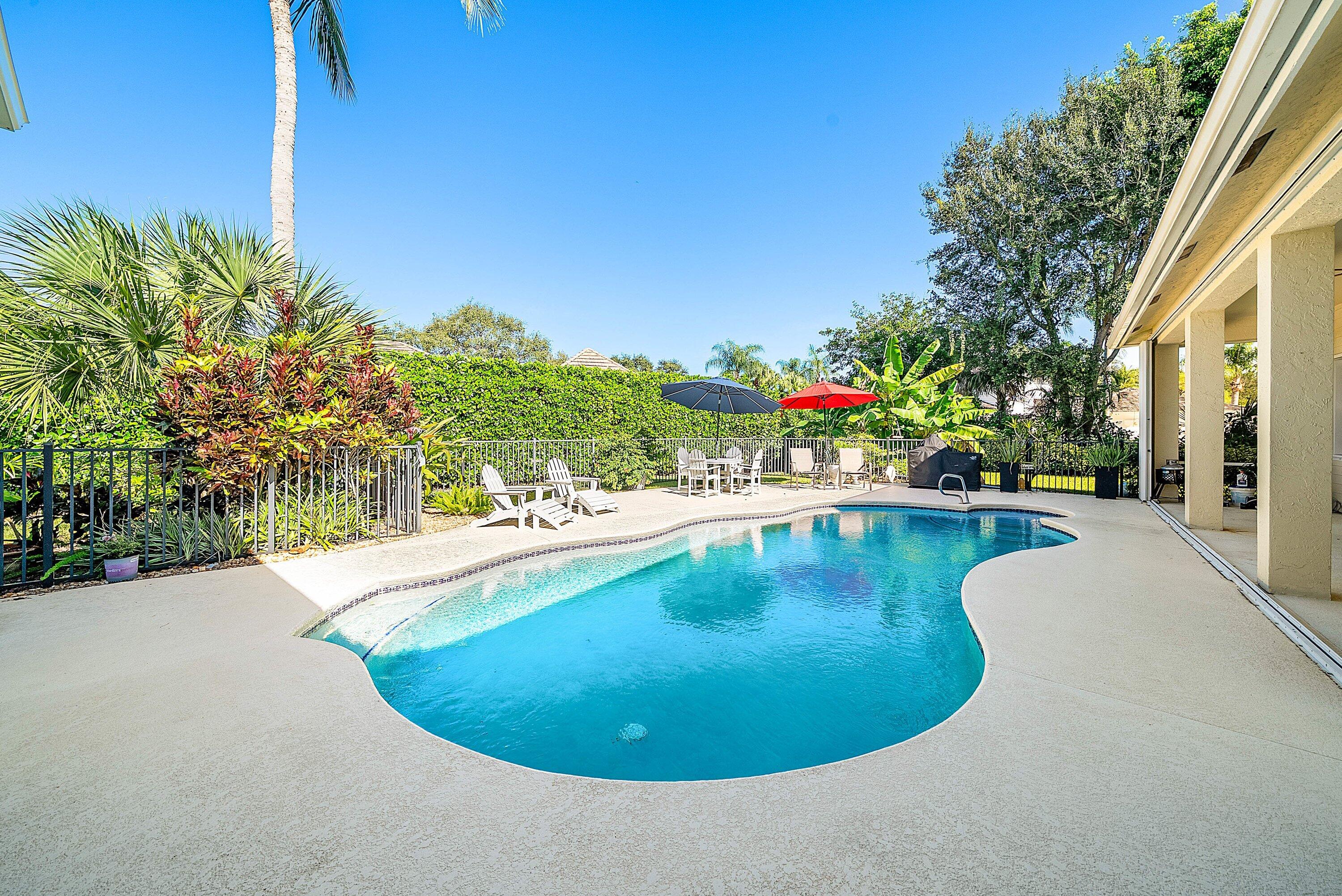 18670 Southeast Lakeside Way Jupiter, FL 33469 - Photo 40 of 56 a view of a swimming pool with an outdoor seating