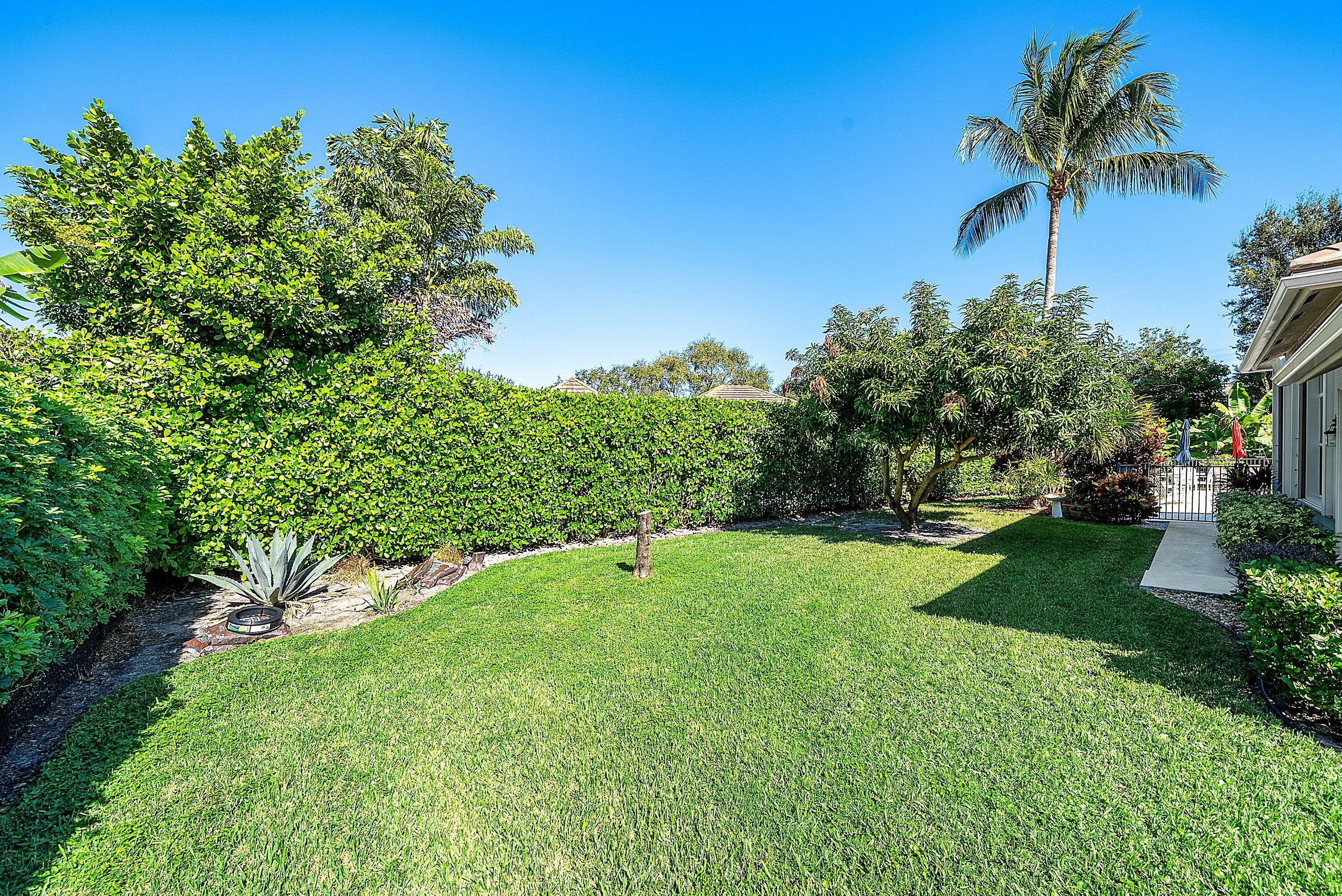 18670 Southeast Lakeside Way Jupiter, FL 33469 - Photo 44 of 56 a view of a garden with a tree