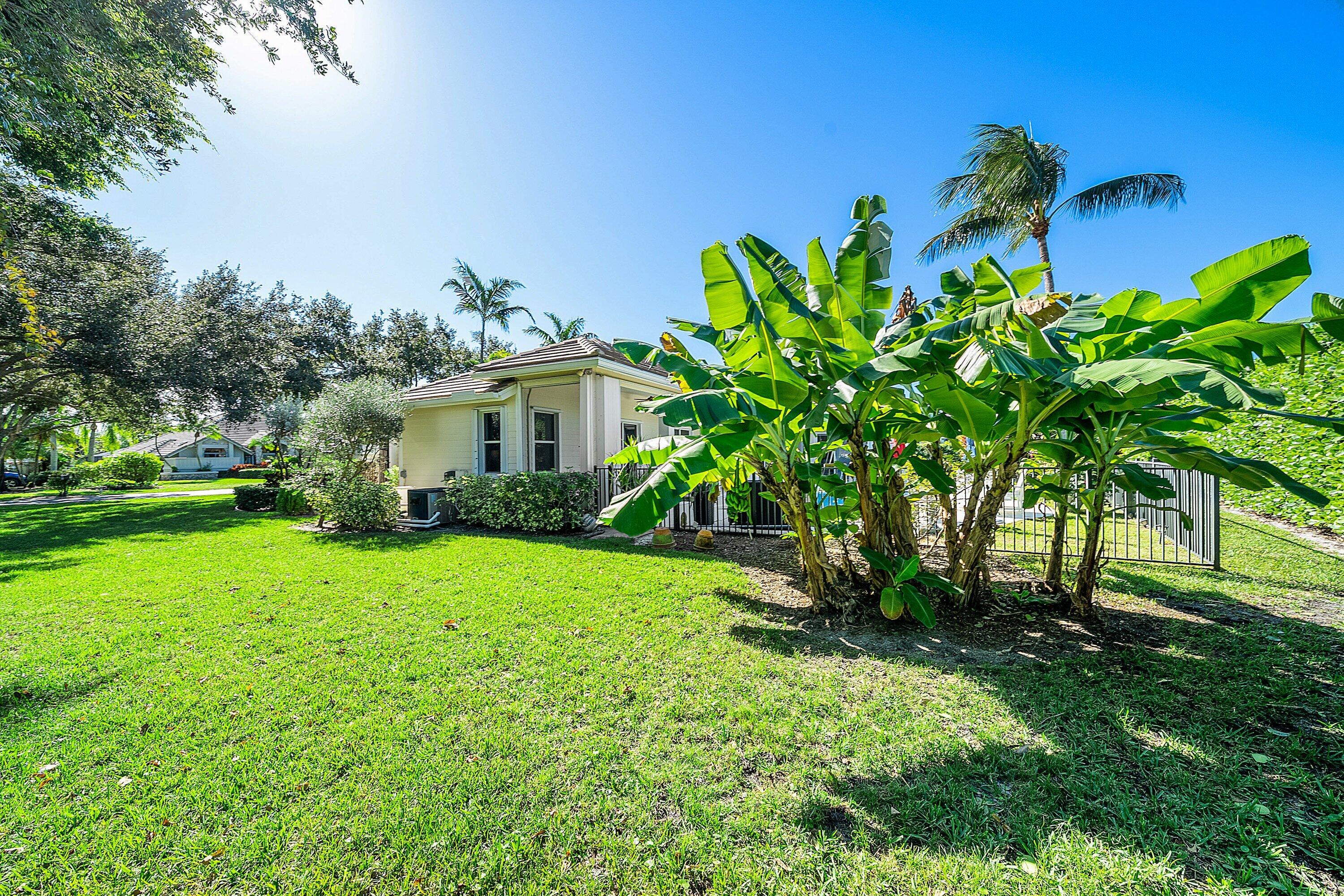 18670 Southeast Lakeside Way Jupiter, FL 33469 - Photo 45 of 56 a view of a house with a yard and a garden