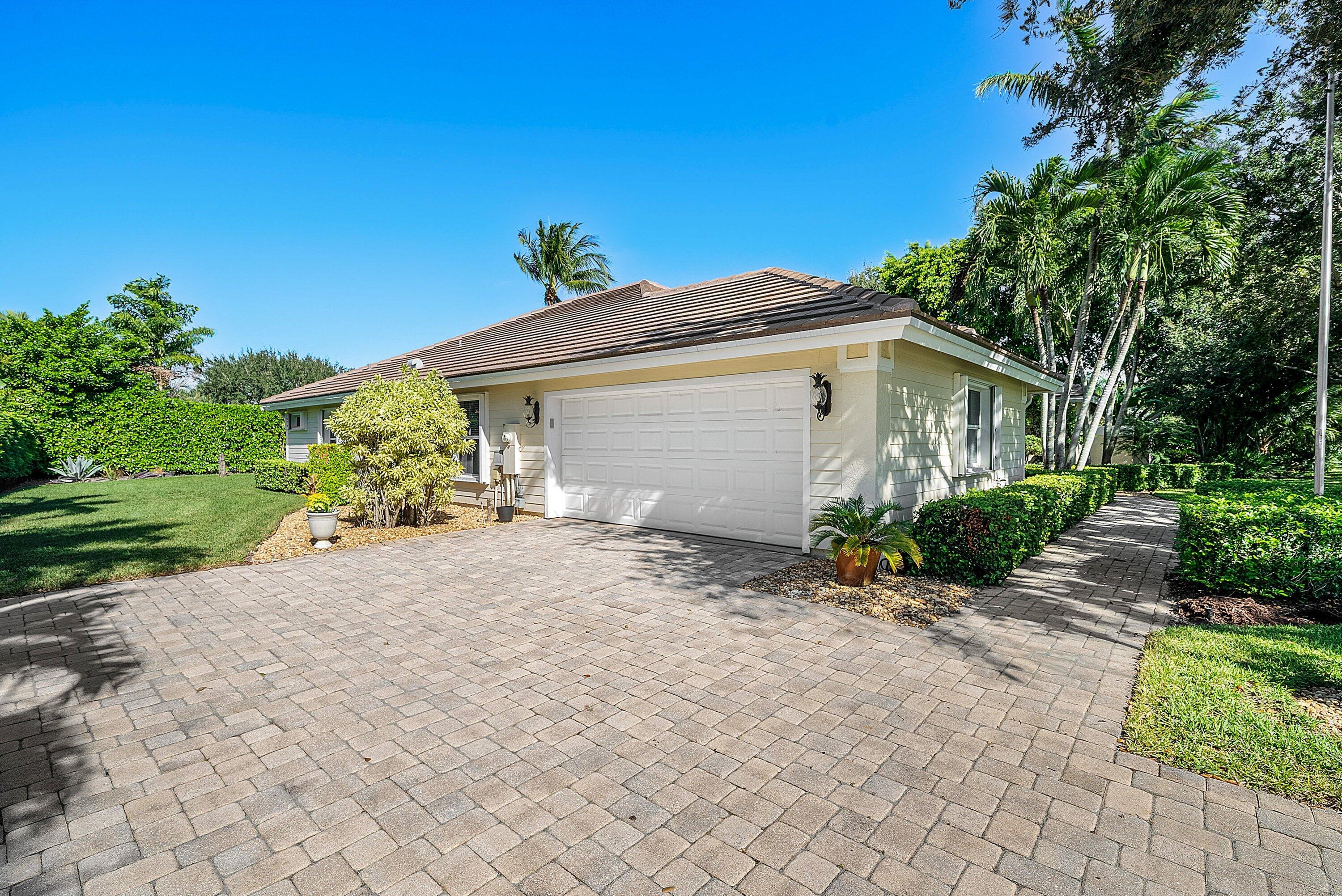 18670 Southeast Lakeside Way Jupiter, FL 33469 - Photo 46 of 56 a view of a house with a yard and potted plants