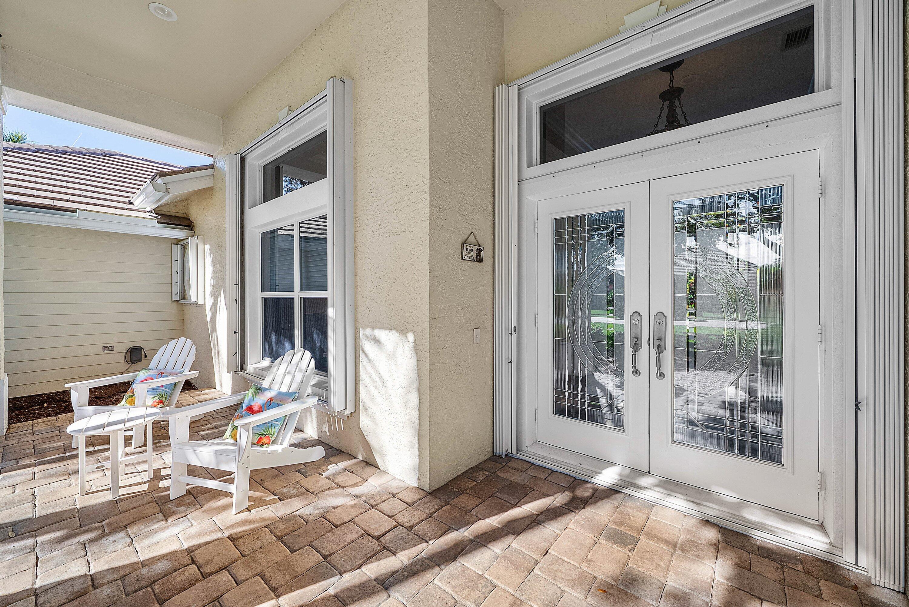 18670 Southeast Lakeside Way Jupiter, FL 33469 - Photo 6 of 56 a living room with a large window and a rug