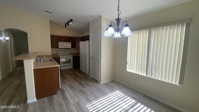 a kitchen with stainless steel appliances a refrigerator and wooden cabinets