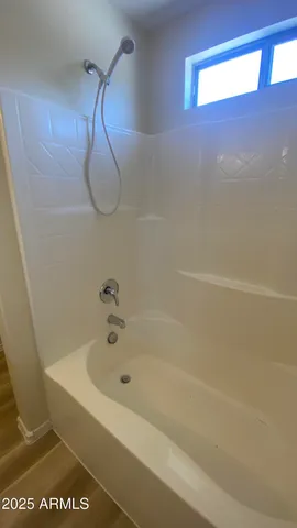 a view of kitchen with kitchen island granite countertop a sink window and refrigerator
