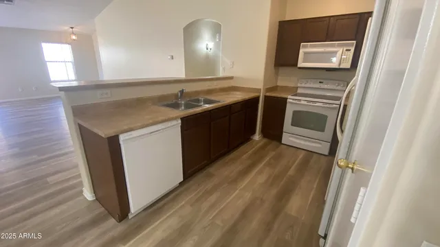 a kitchen with a sink stove and microwave