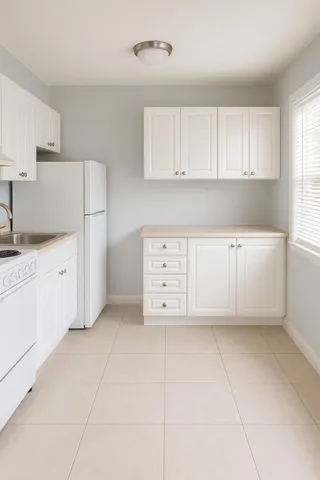 a view of white cabinets and window