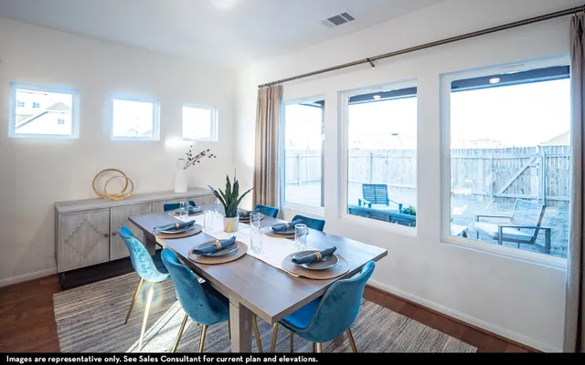a dining room with furniture a rug and wooden floor