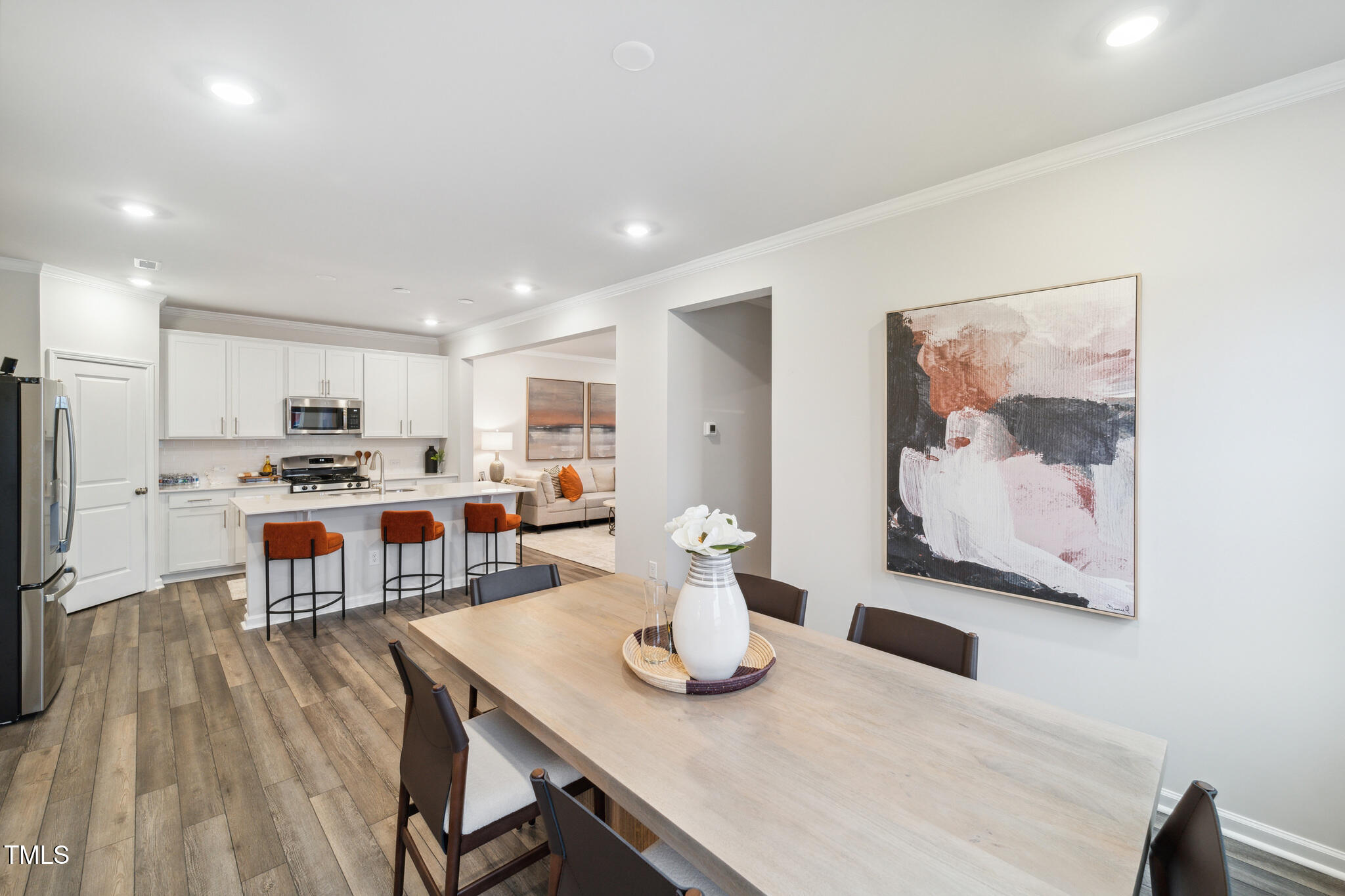 1422 Maple Br Circle Graham, NC 27253 - Photo 11 of 45 a kitchen with a dining table chairs and refrigerator