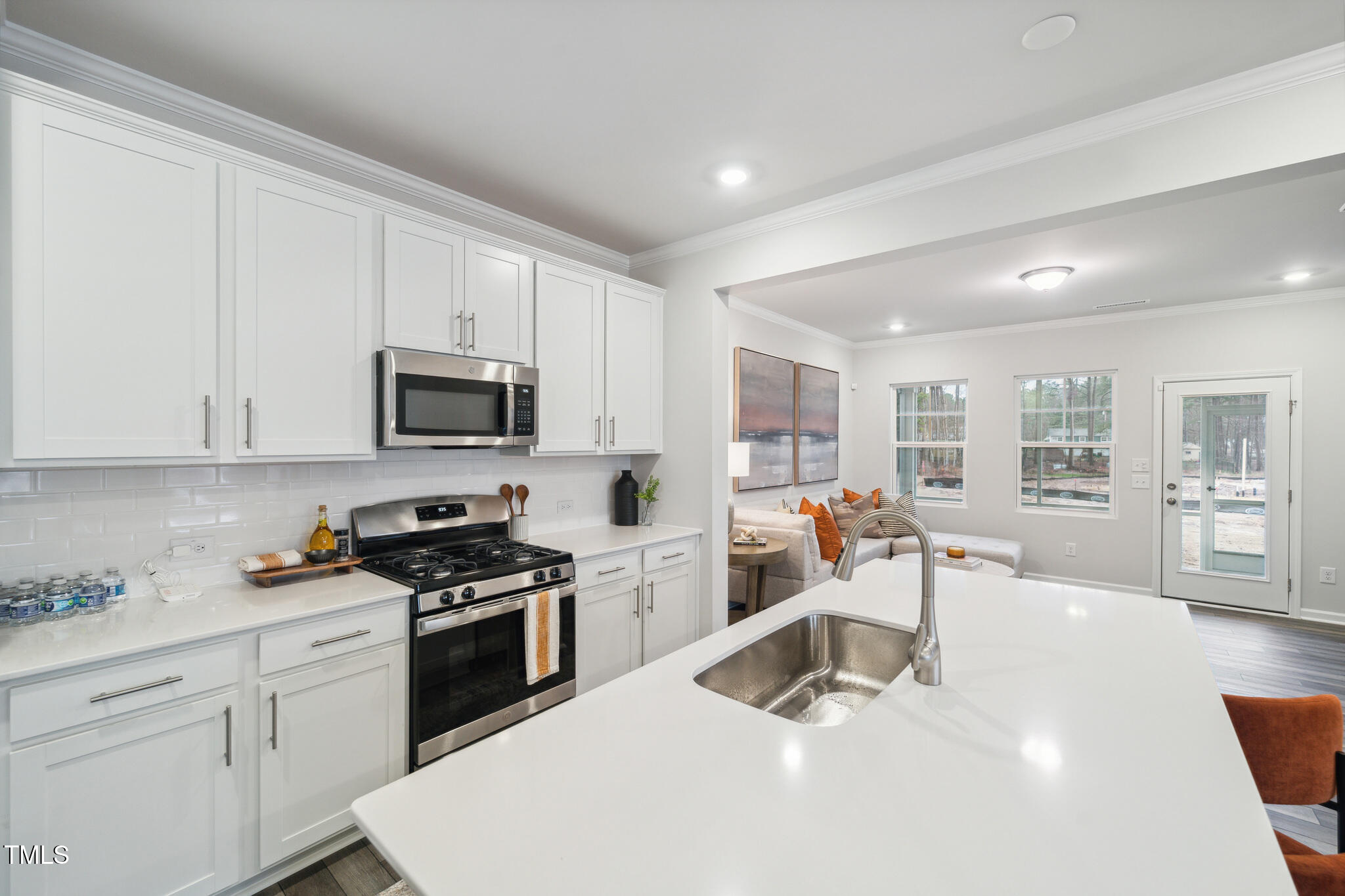 1422 Maple Br Circle Graham, NC 27253 - Photo 12 of 45 a kitchen with granite countertop a sink stainless steel appliances and white cabinets