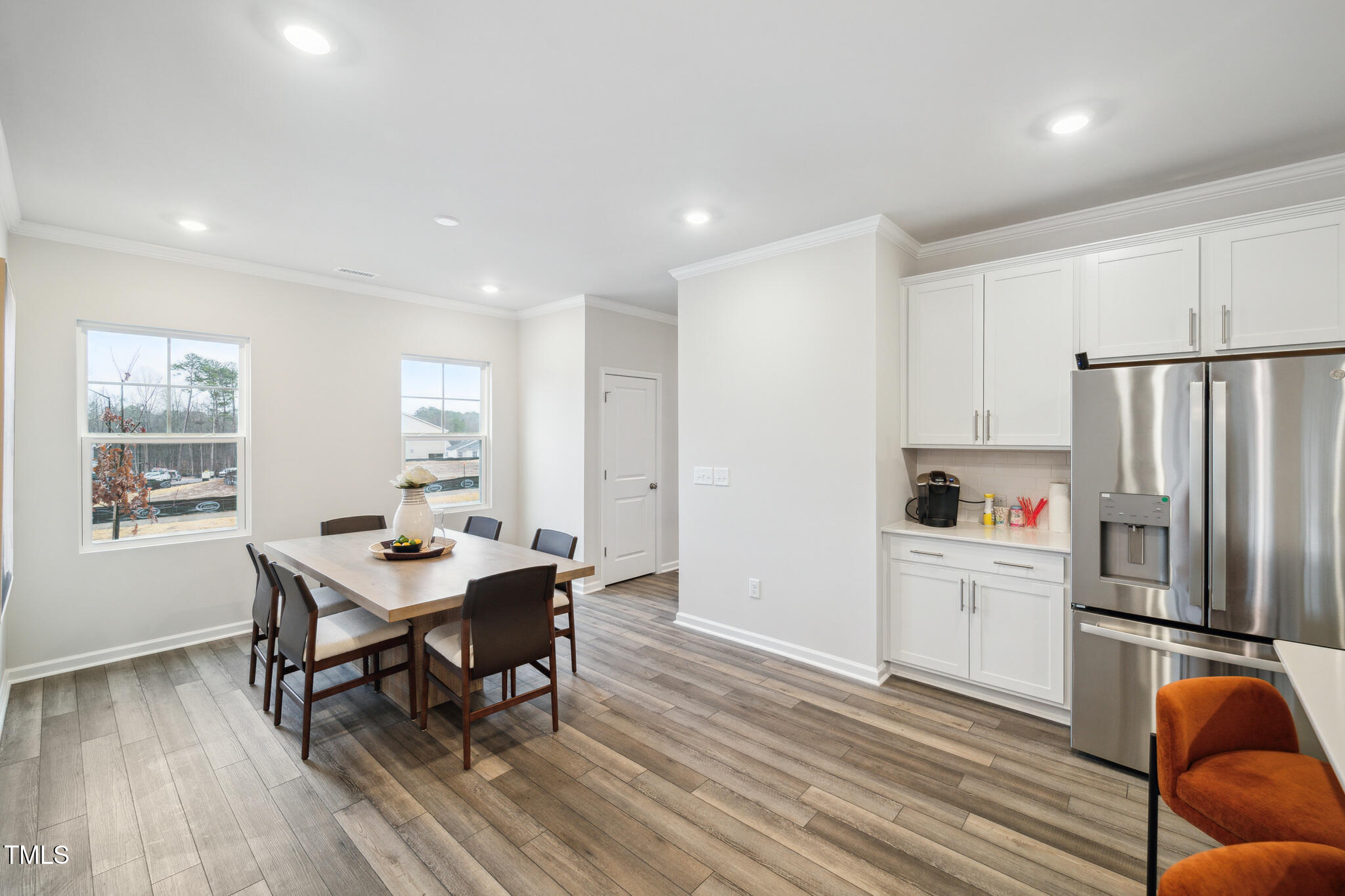 1422 Maple Br Circle Graham, NC 27253 - Photo 20 of 45 a kitchen with stainless steel appliances a refrigerator a table and chairs
