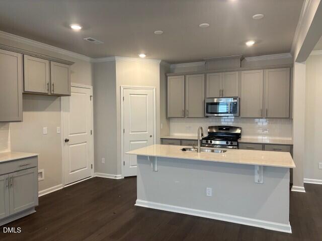 1422 Maple Br Circle Graham, NC 27253 - Photo 3 of 45 a kitchen with wooden cabinets and stainless steel appliances