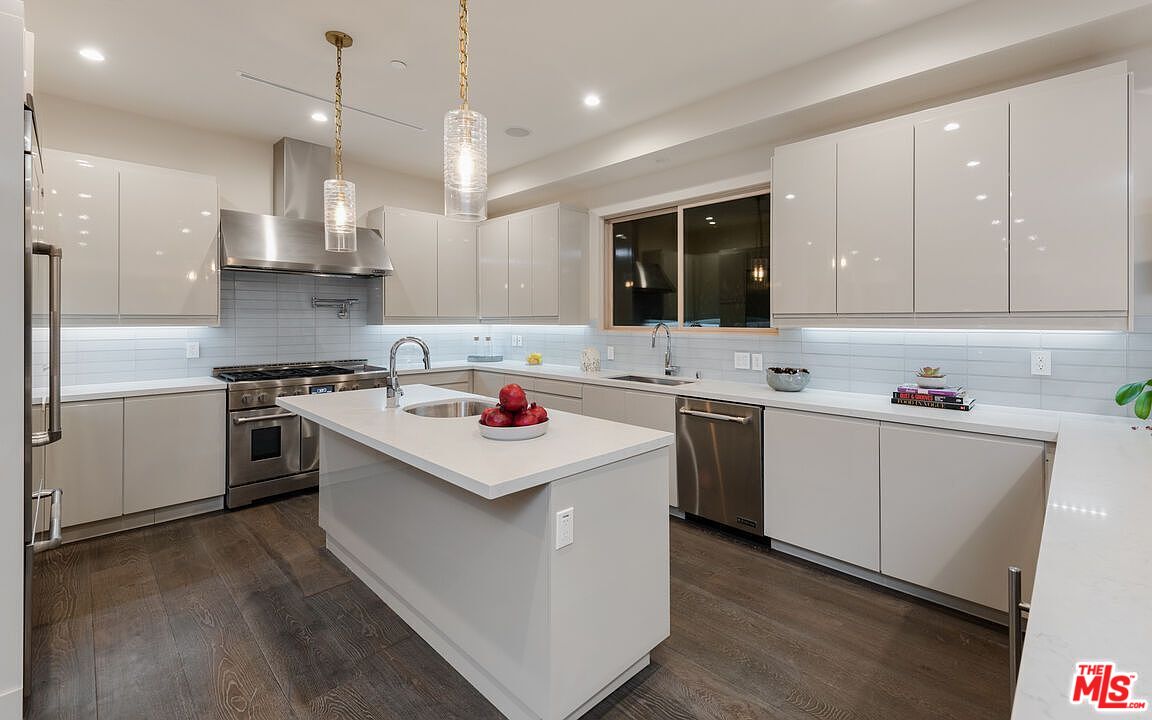 2408 Castle Heights Avenue Los Angeles, CA 90034 - Photo 12 of 28 a kitchen that has a sink a stove and chairs